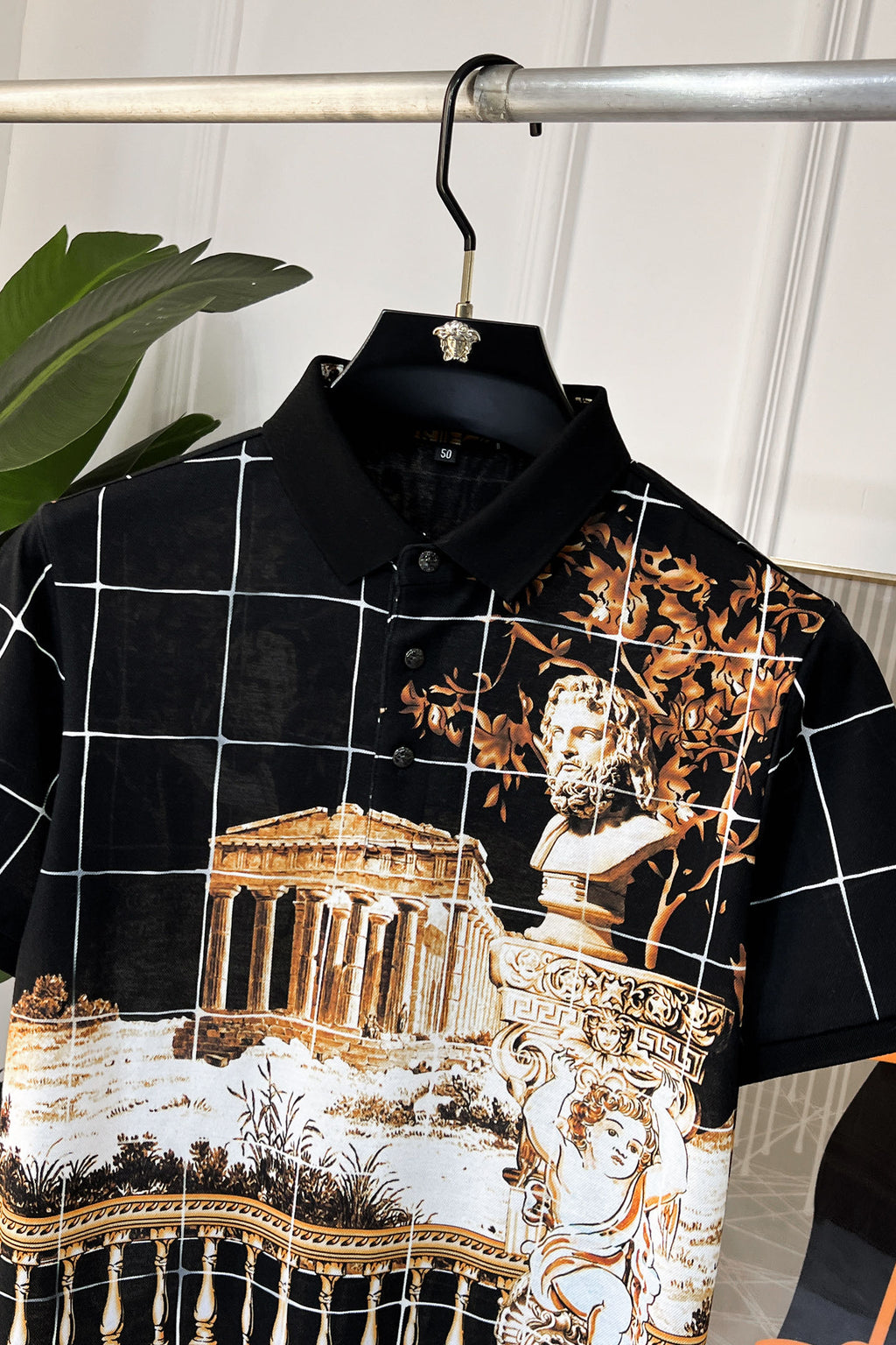 Versace short-sleeve shirt close-up, black with white grid lines and gold baroque artwork