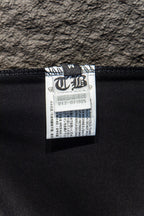 Black T-shirt interior fabric label near neckline seam