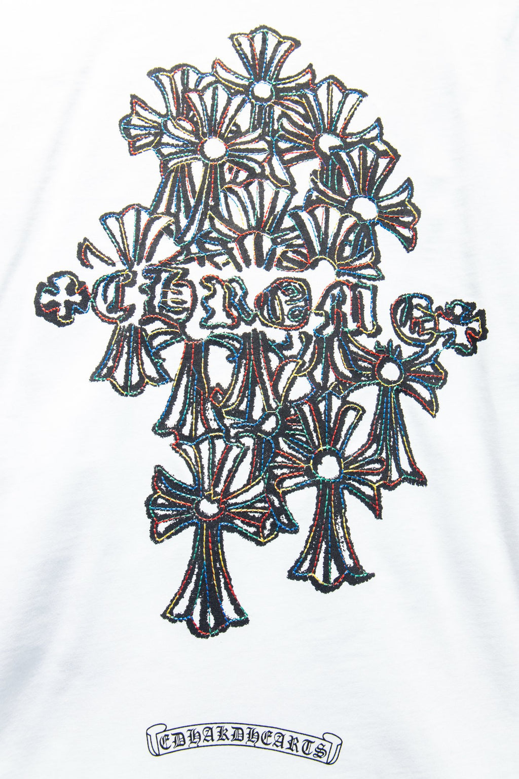 White T-shirt close-up of floral crown graphic and rectangular logo text