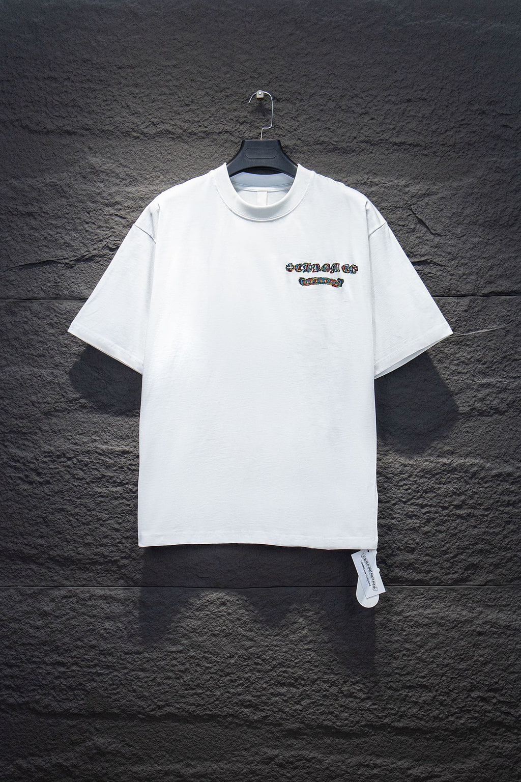 White short-sleeve T-shirt with small chest logo graphic and crew neckline
