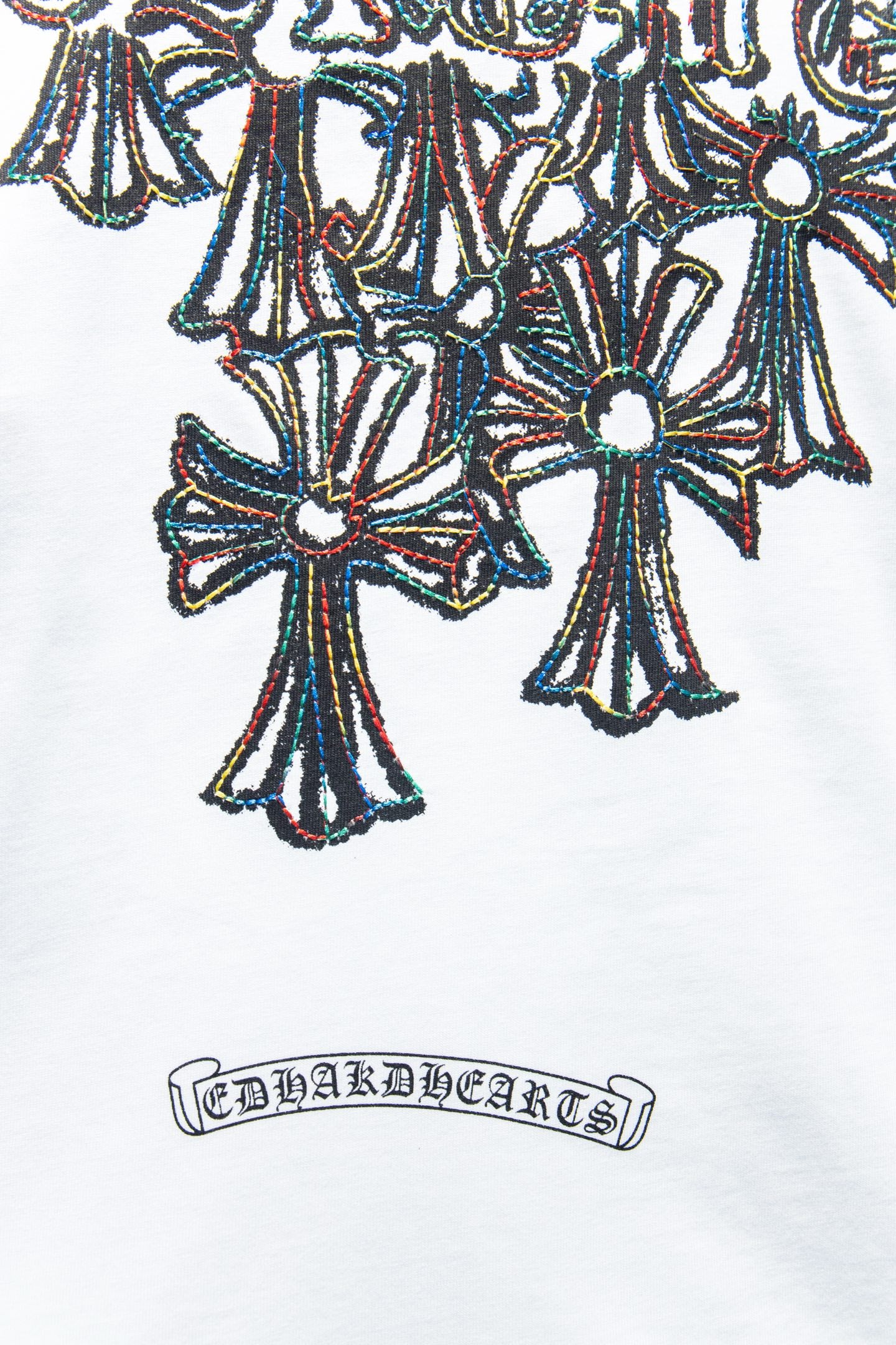 White T-shirt close-up of large multicolor floral graphic with decorative border