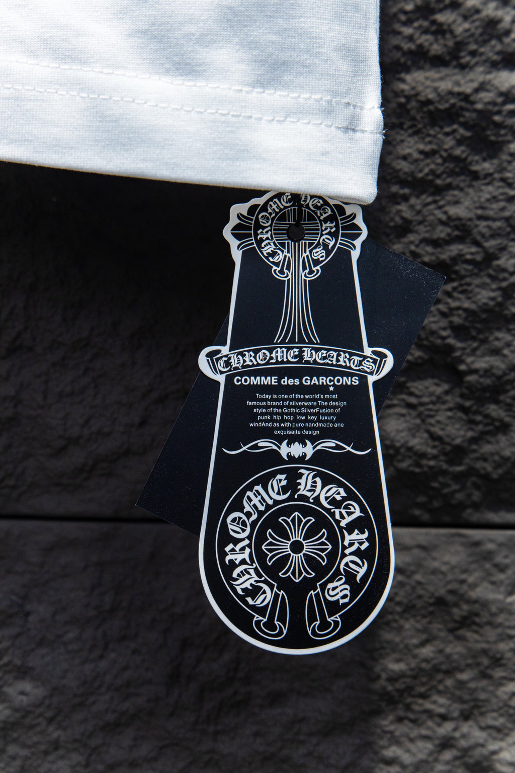 White T-shirt neck label tag with black and white branding text