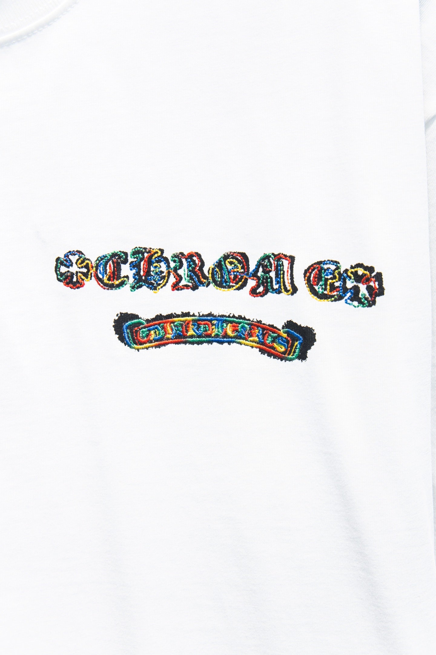 White T-shirt chest logo print with multicolor lettering and small rectangular badge