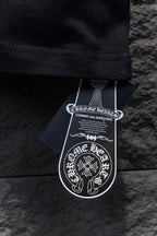 Black short-sleeve T-shirt hem with white hanging brand tags
