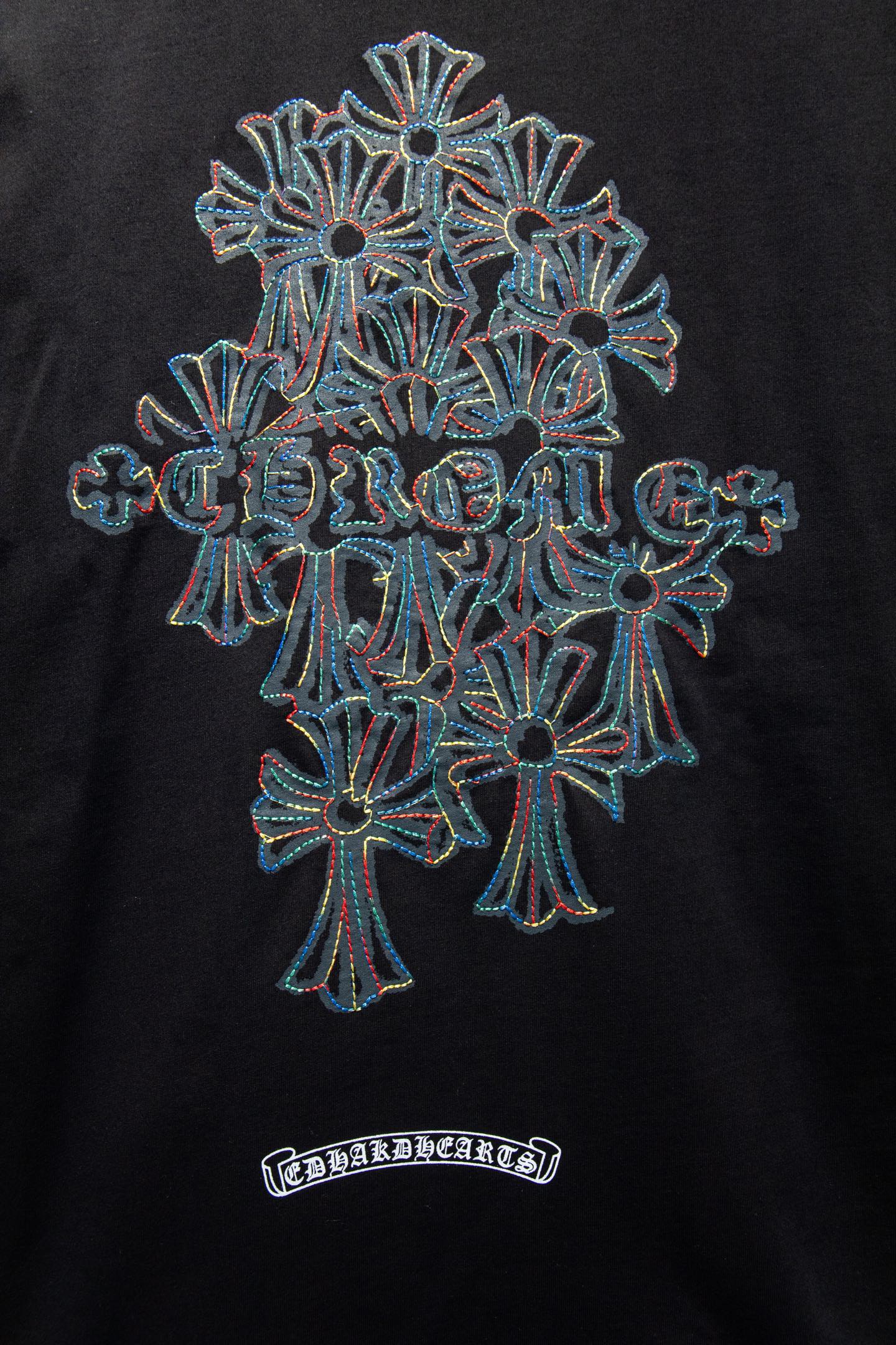 Black T-shirt with large multi-flower emblem embroidery and small label