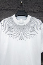 White short-sleeve T-shirt with studded sunburst detail and cross charm accents