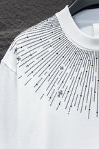 Embellished T-shirt sleeve with studded dot pattern and cross charms