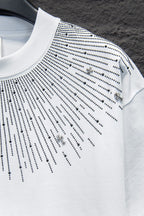 Embellished white T-shirt with studded lines and small cross charm accents