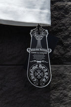 Black and white clothing tag attached to the T-shirt hem