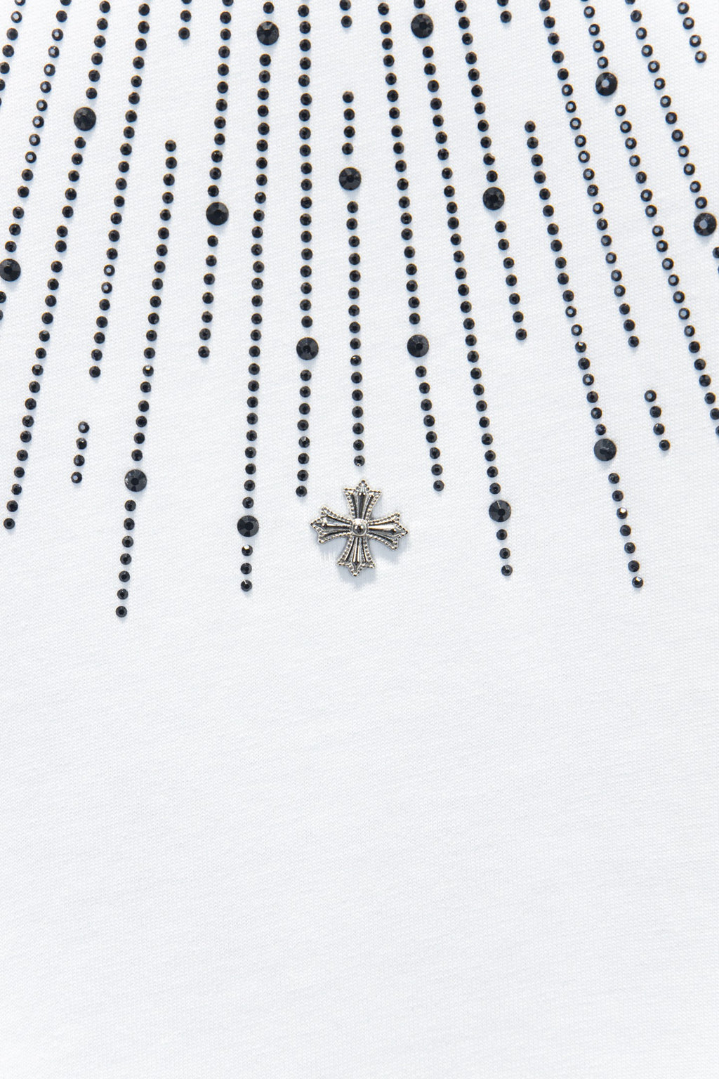 Embellished chest detail with star-shaped cross charm on a white T-shirt