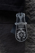Chrome short-sleeve top on hanger with clothing tag
