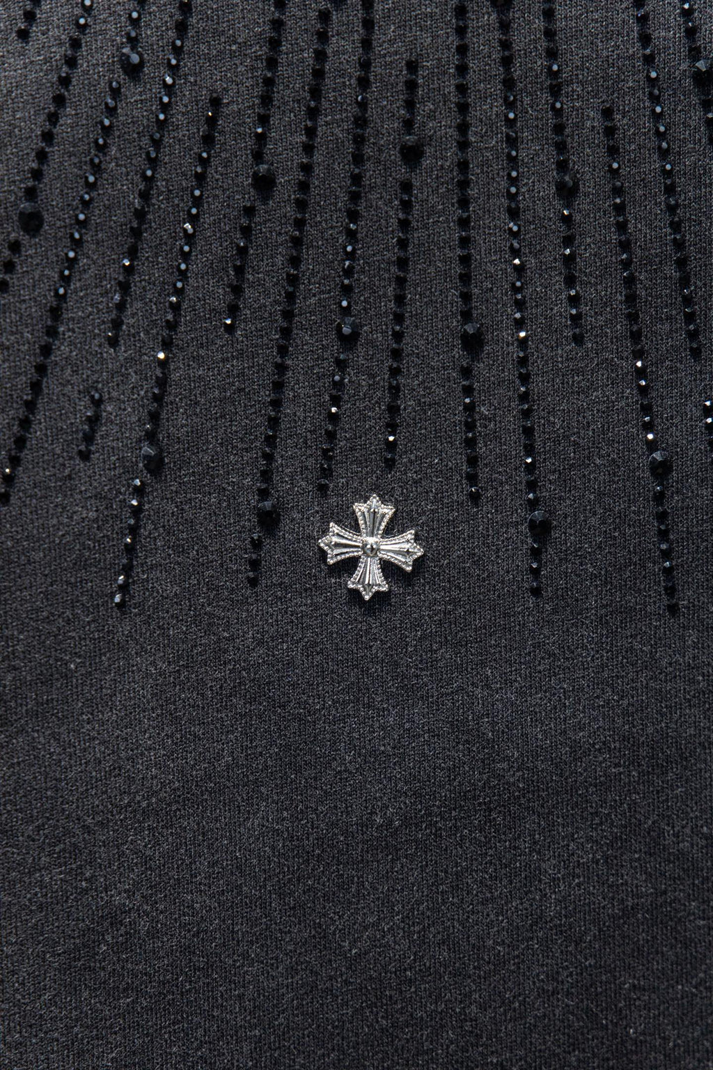 Chrome short-sleeve top, black knit with small cross emblem pin