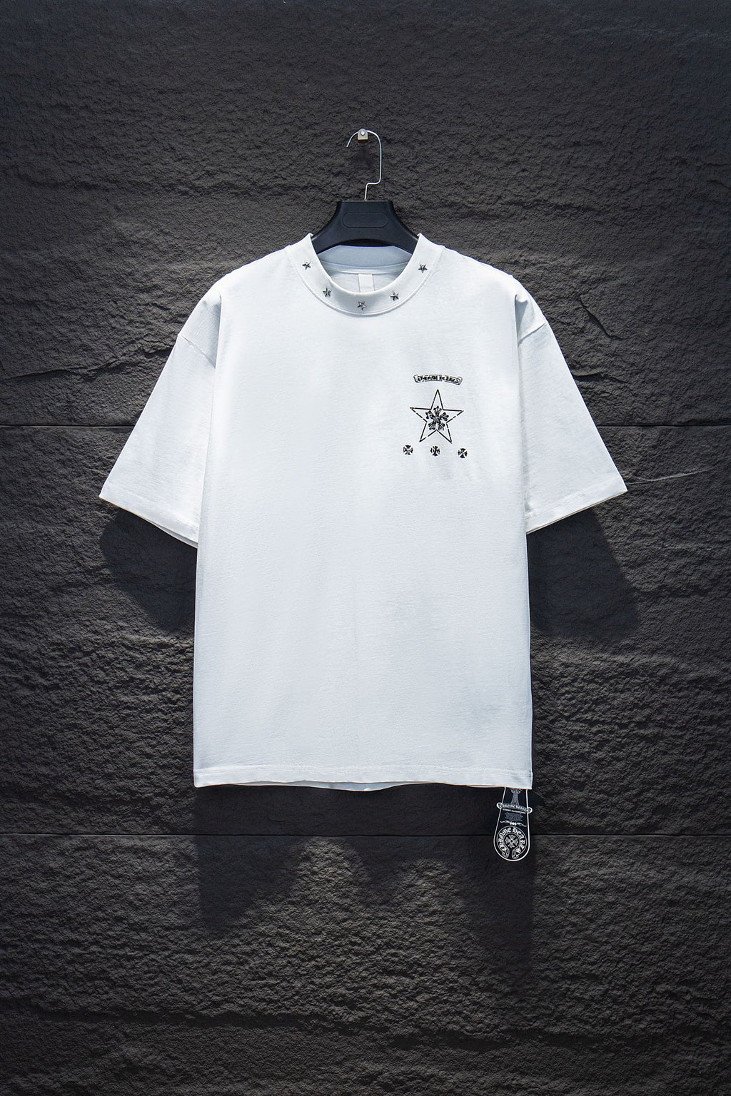 White short-sleeve crewneck T-shirt with small star and crest graphic on chest