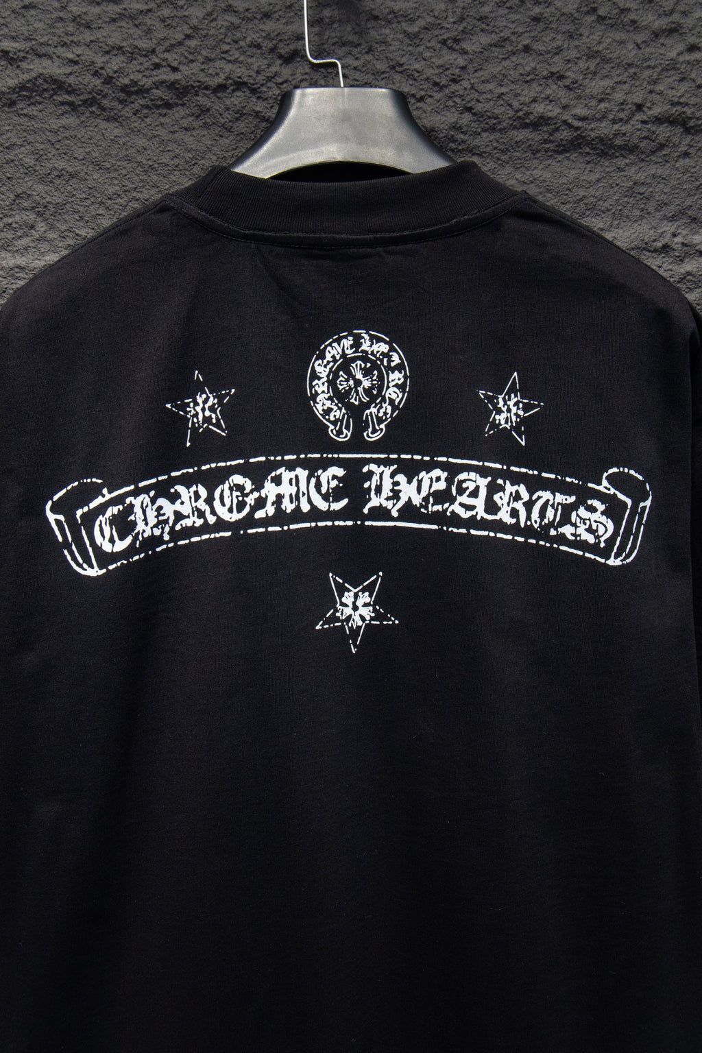 Black T-shirt back with centered arch logo and star icons