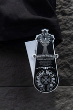Black T-shirt with hanging white brand tag and black graphic crest