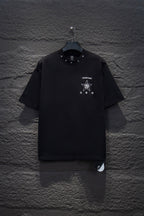 Black short-sleeve T-shirt with small chest star and logo graphic