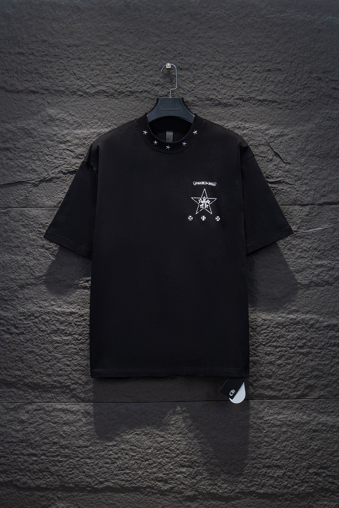 Black short-sleeve T-shirt with small chest star and logo graphic