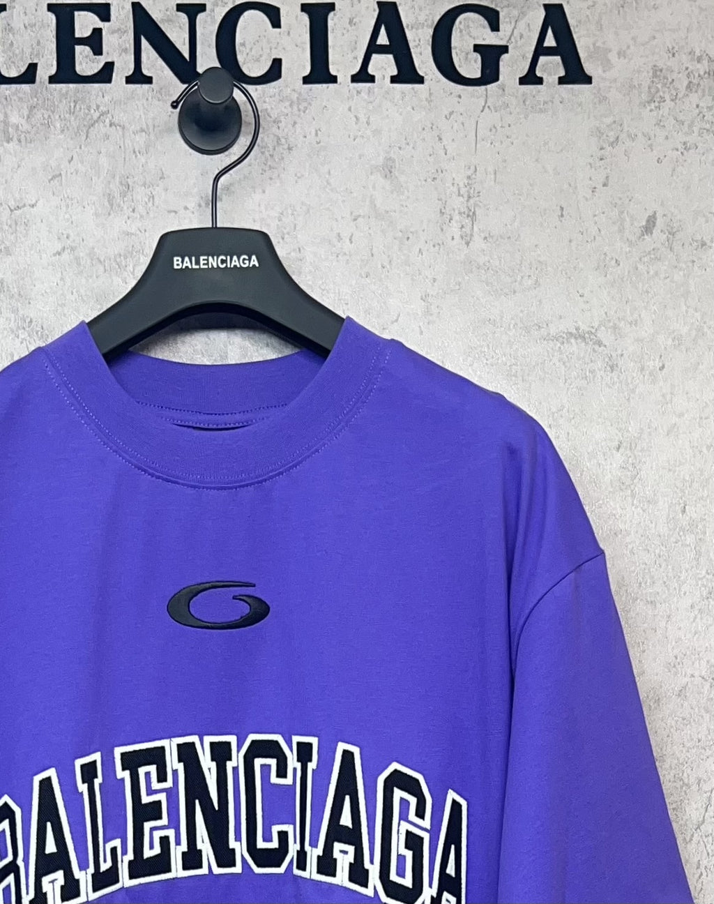 Purple T-shirt with small oval logo on chest