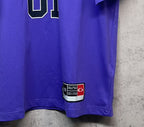 Purple T-shirt hem with red-and-white label patch