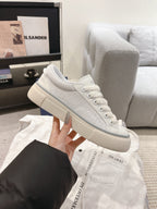 White textured Dior low-top sneakers with lace-up and padded collar