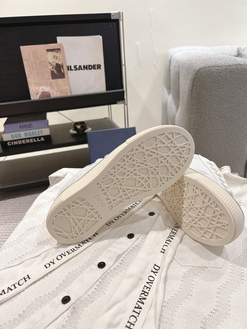 White Dior sneakers outsole view with patterned tread and side branding