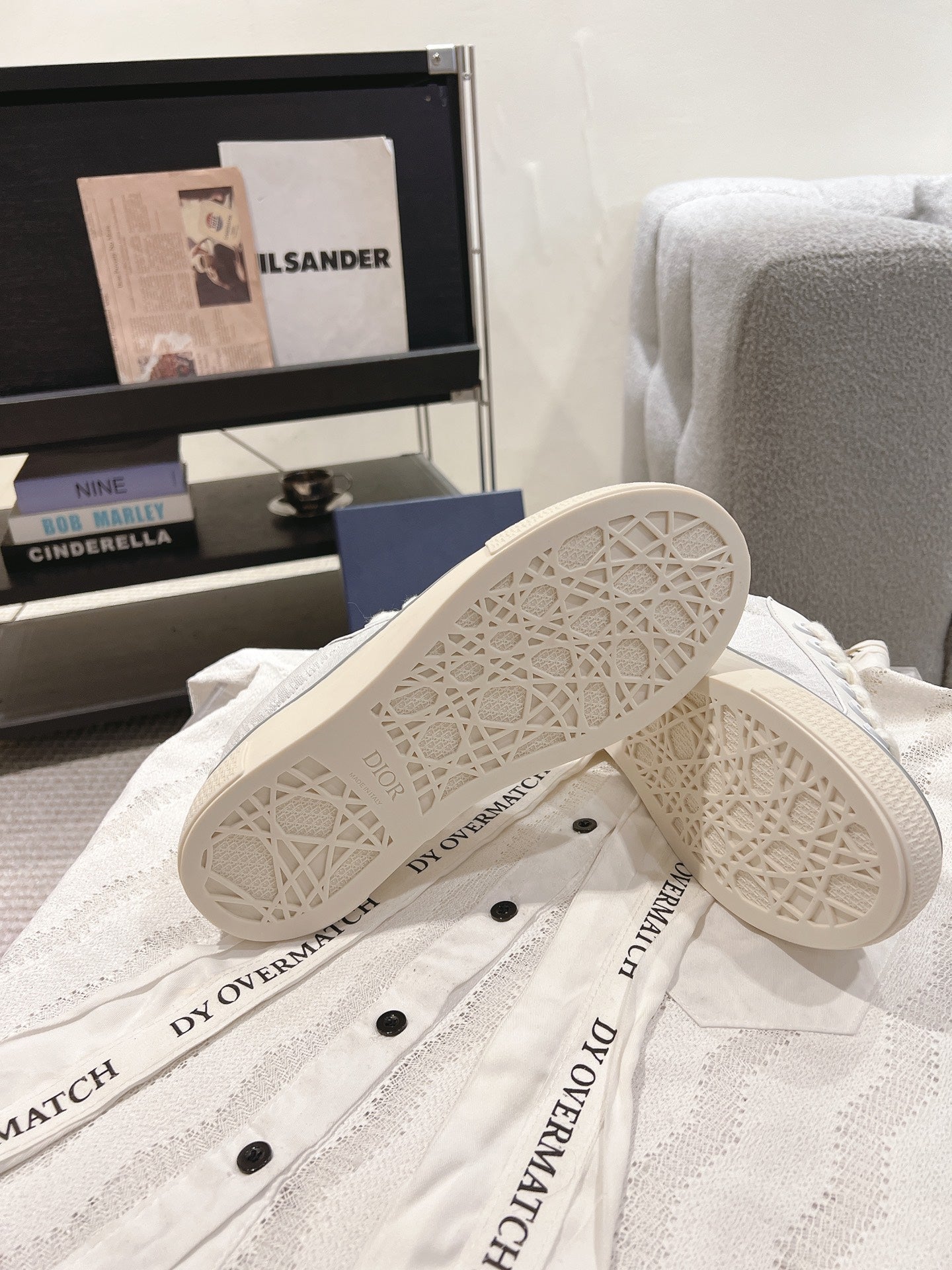 White Dior sneakers outsole view with patterned tread and side branding