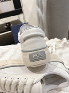 White Dior sneakers heel view showing Dior logo on back tab