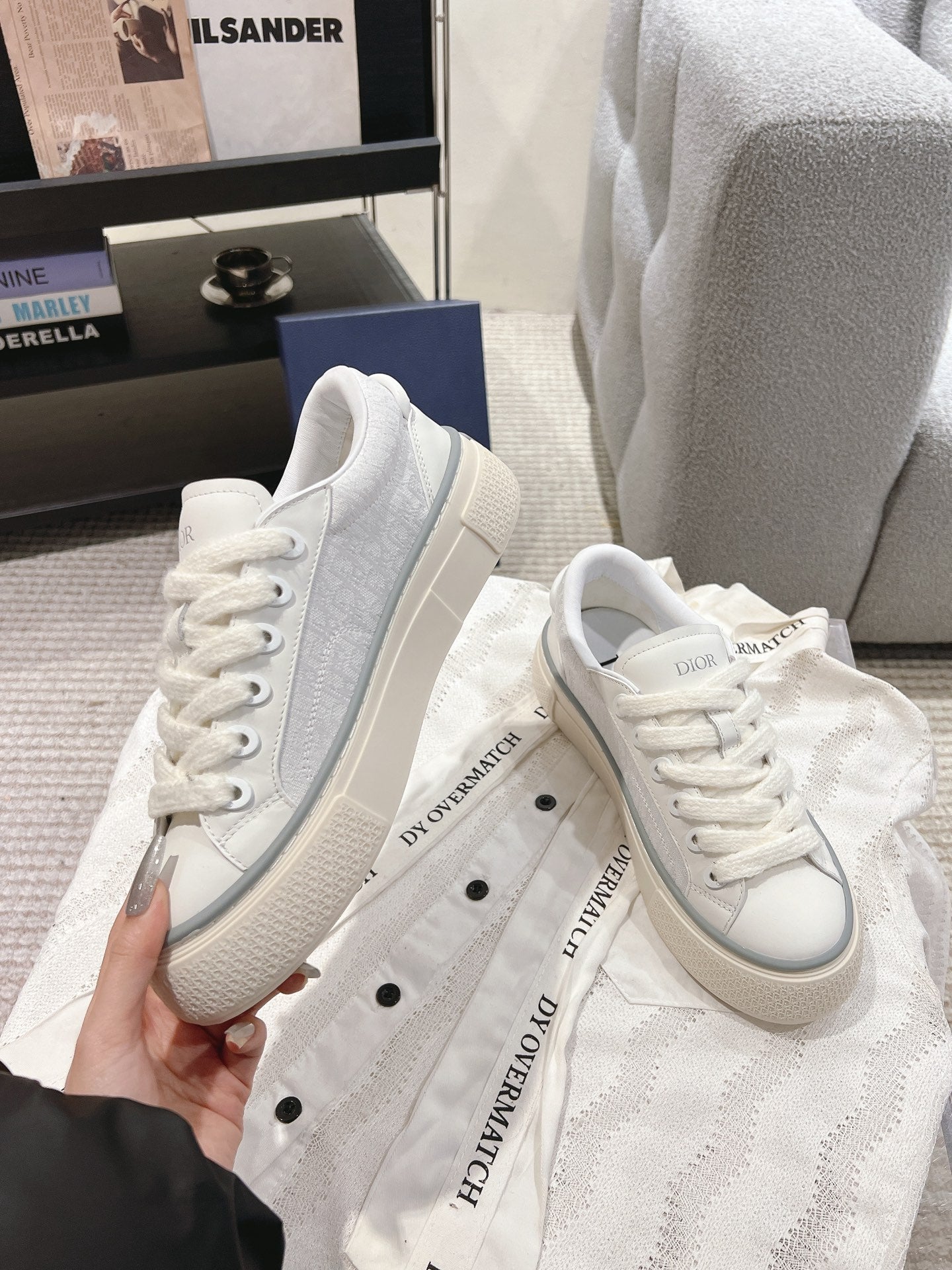 Pair of white Dior lace-up sneakers with gray-trim rubber sole