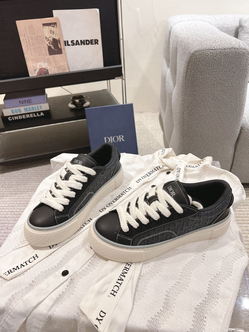 Pair of unisex low-top sneakers in dark gray with white laces and off-white midsoles