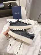 Stacked unisex low-top sneakers, dark gray textured uppers with white laces and off-white soles