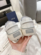 Low-top Dior sneakers heel view, gray logo tab with cushioned back collar