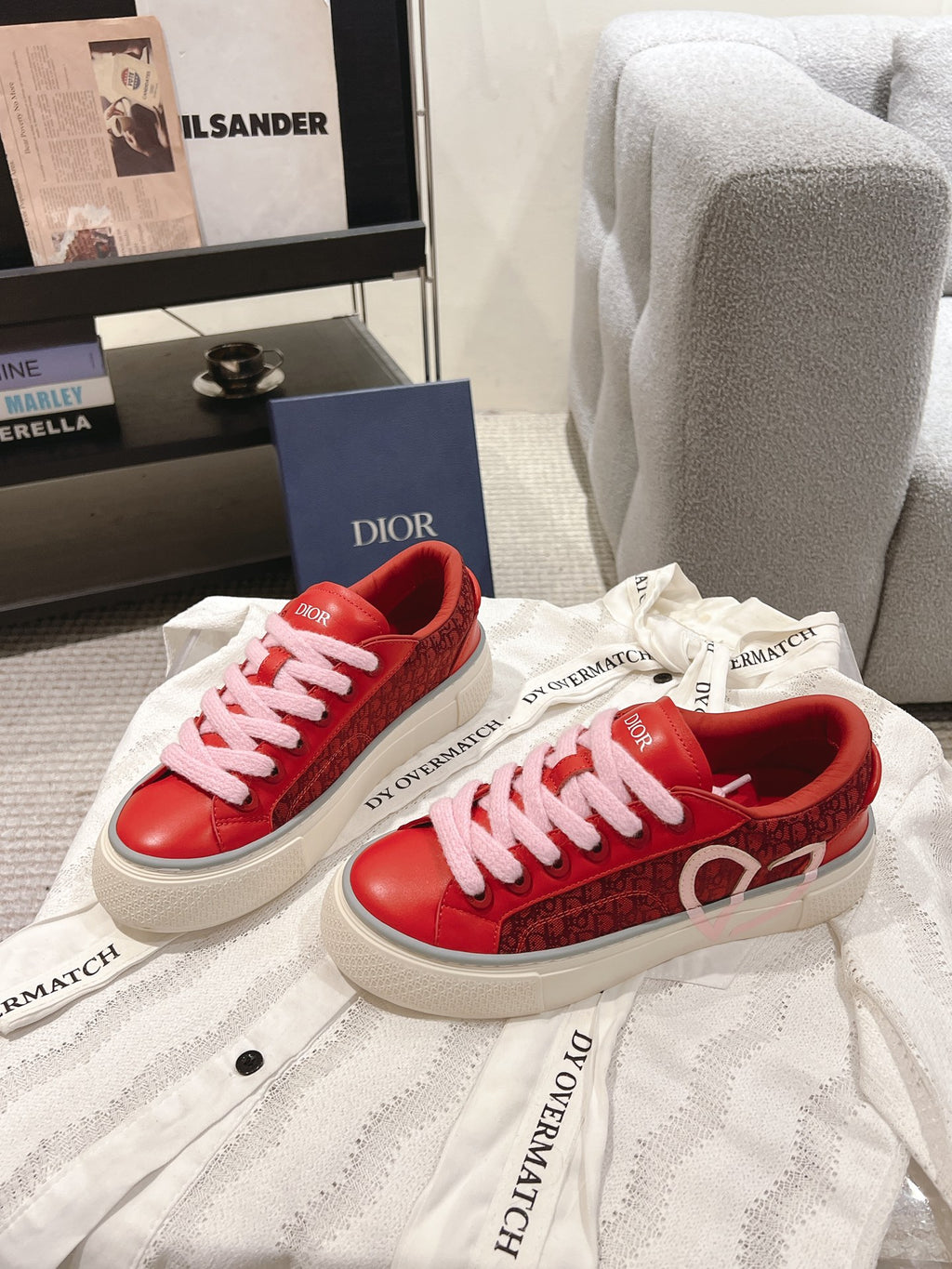 Red Dior low-top sneakers with pink laces, side branding and white sole