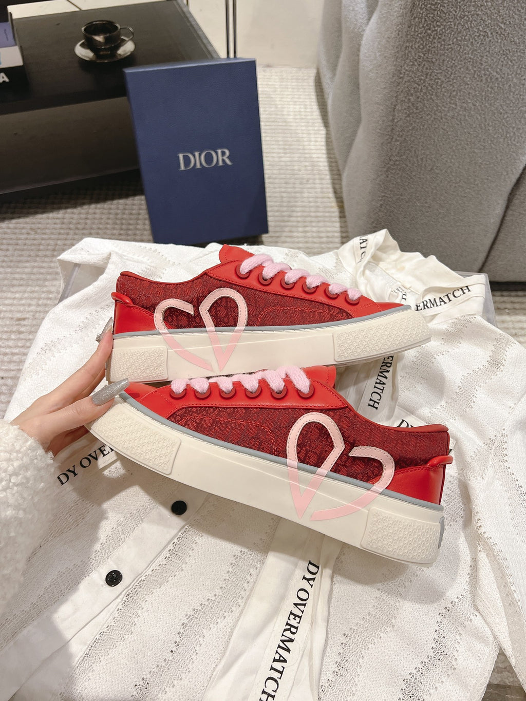 Red Dior low-top sneakers with heart motif on side and pink laces