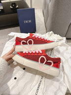Red Dior low-top sneakers with heart motif on side and pink laces