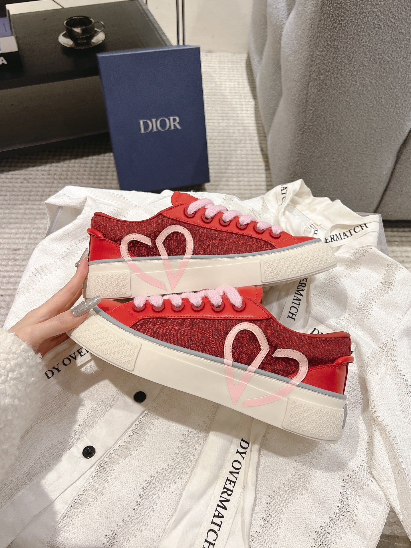 Red Dior low-top sneakers with heart motif on side and pink laces