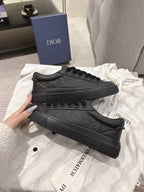 Dior unisex black lace-up sneakers with embossed pattern across the side