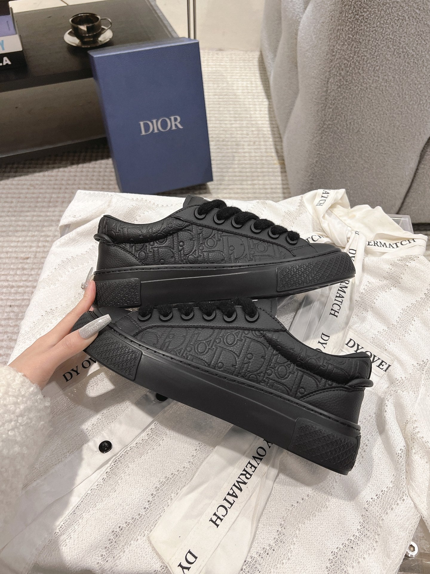 Dior unisex black lace-up sneakers with embossed pattern across the side