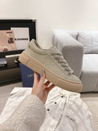 Unisex low-top sneaker in light gray-beige with textured upper and lace closure
