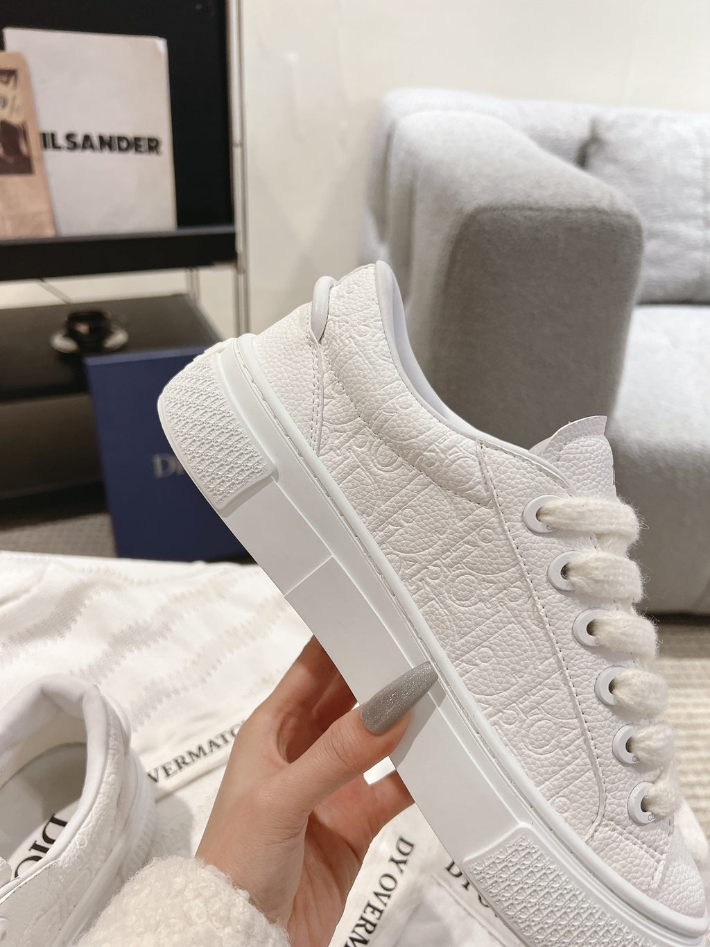 White low-top sneaker with lace-up front and textured side panels