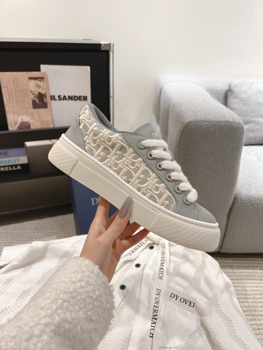 Gray-and-beige Dior monogram low-top sneakers with white laces and thick sole