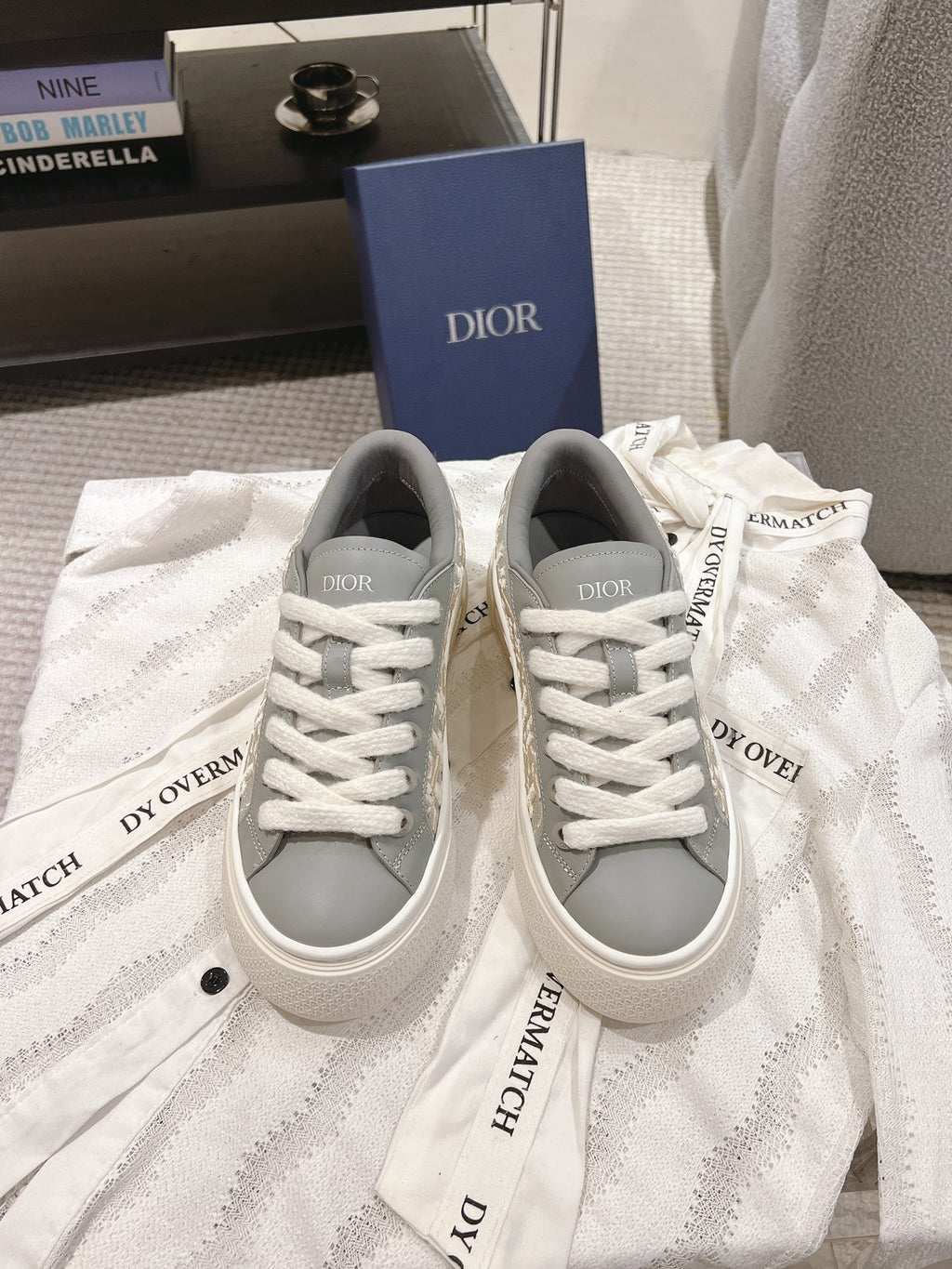 White low-top sneakers with gray collar and white lace-up, DIOR on tongue