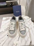 White low-top sneakers with gray collar and white lace-up, DIOR on tongue