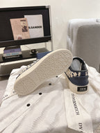 Navy and white sneaker soles with tread pattern and Dior logo heel label