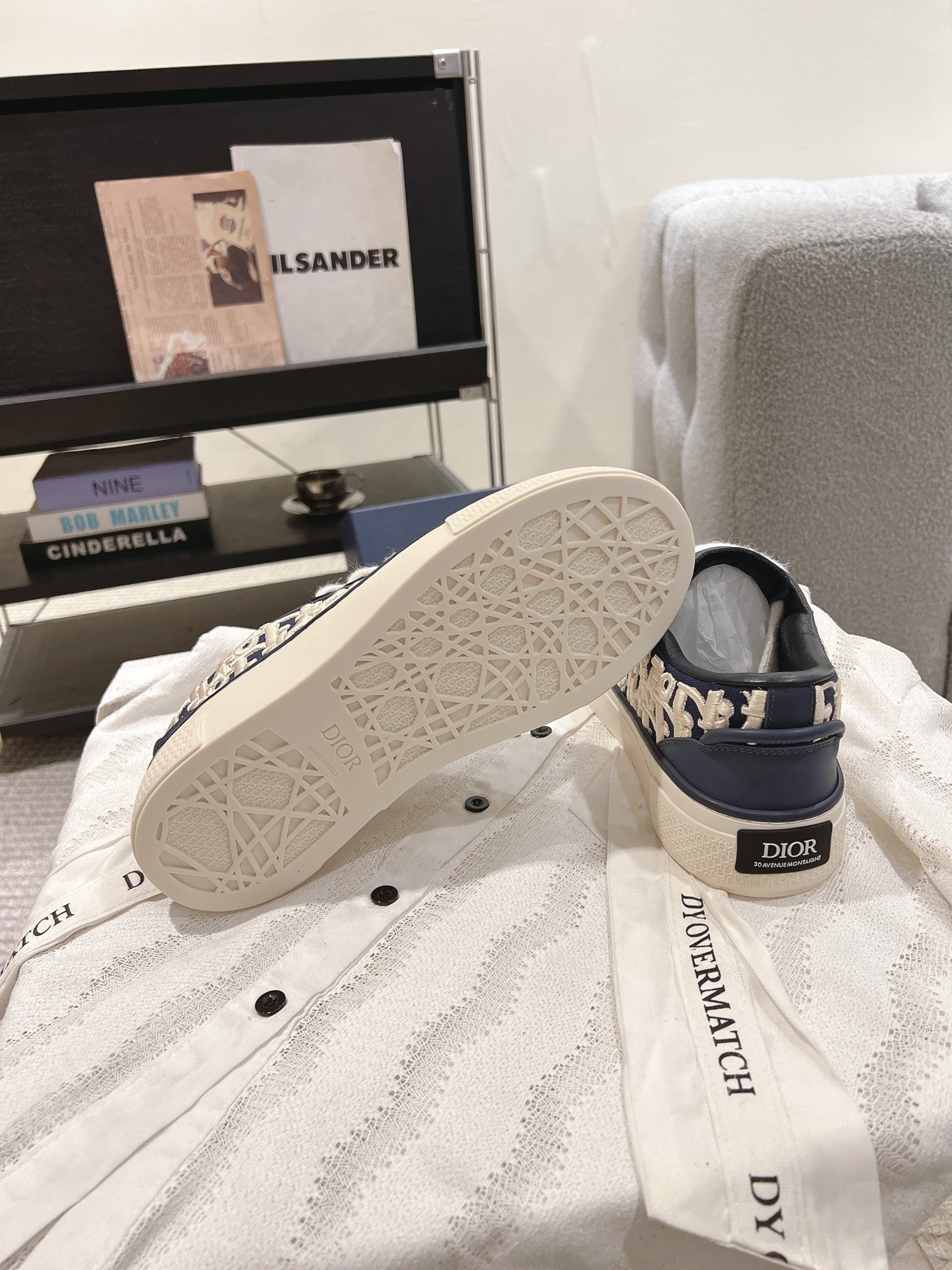 Navy and white sneaker soles with tread pattern and Dior logo heel label
