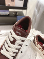 Dior unisex sneakers close-up, dark brown leather with white laces and Dior logo tongue