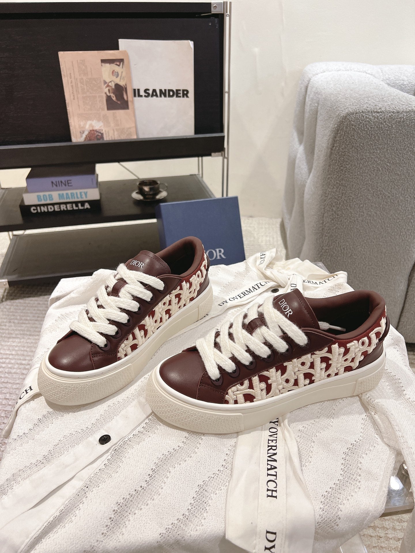 Dior unisex sneakers with burgundy patterned side panels, white laces, cream sole