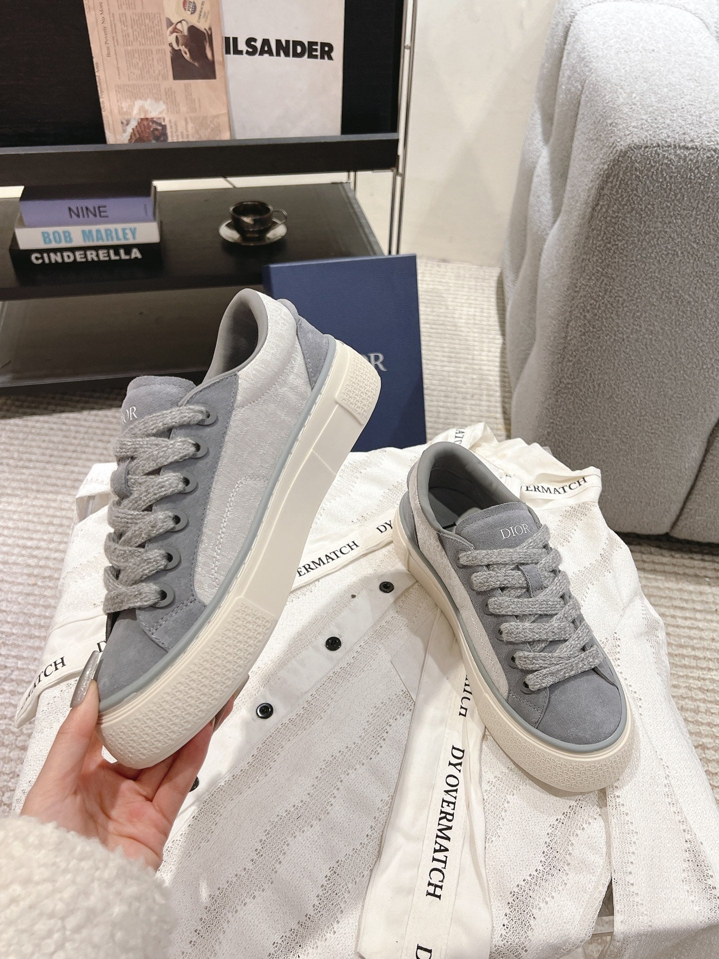 Gray Dior unisex lace-up sneakers, close-up view of laces and off-white sole