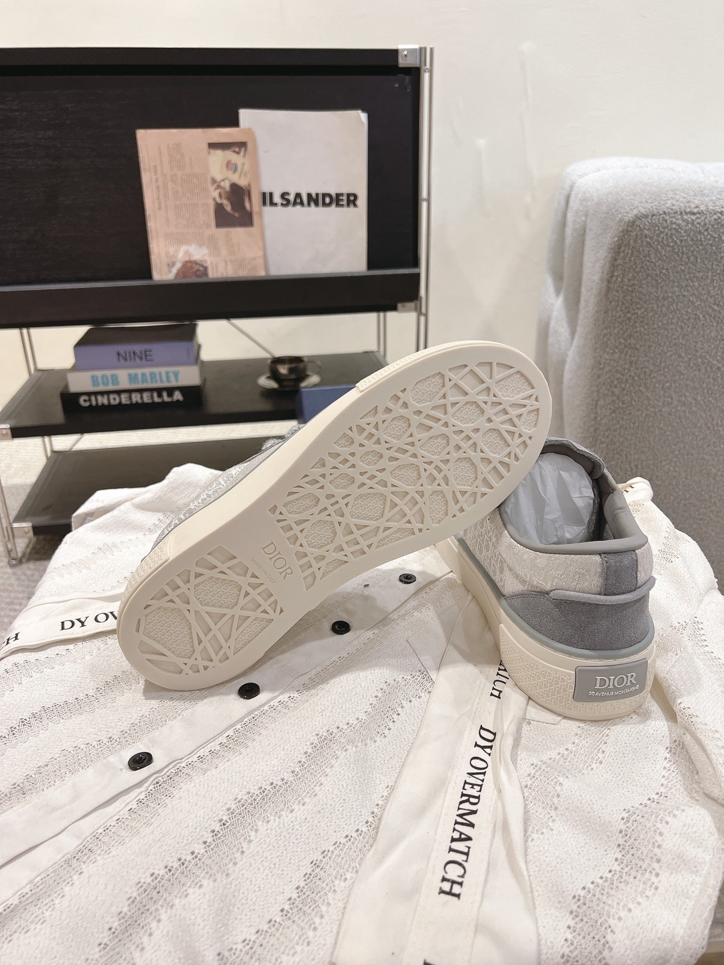 Gray Dior unisex sneakers with perforated outsole pattern and off-white tread