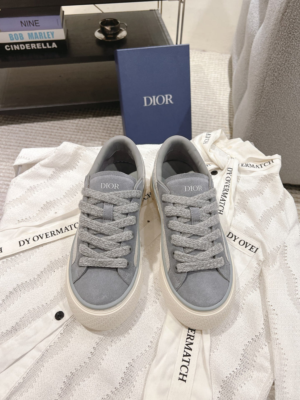 Gray Dior unisex lace-up sneakers with textured fabric and off-white rubber sole