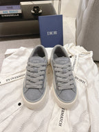 Gray Dior unisex lace-up sneakers with textured fabric and off-white rubber sole